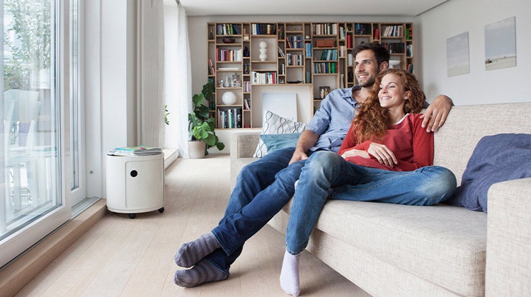 Couple sitting on a couch relaxing in their space 