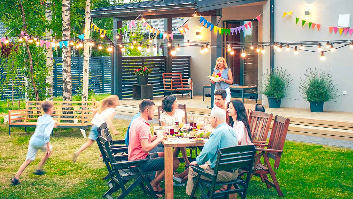 Large family enjoying dinner in the backyard