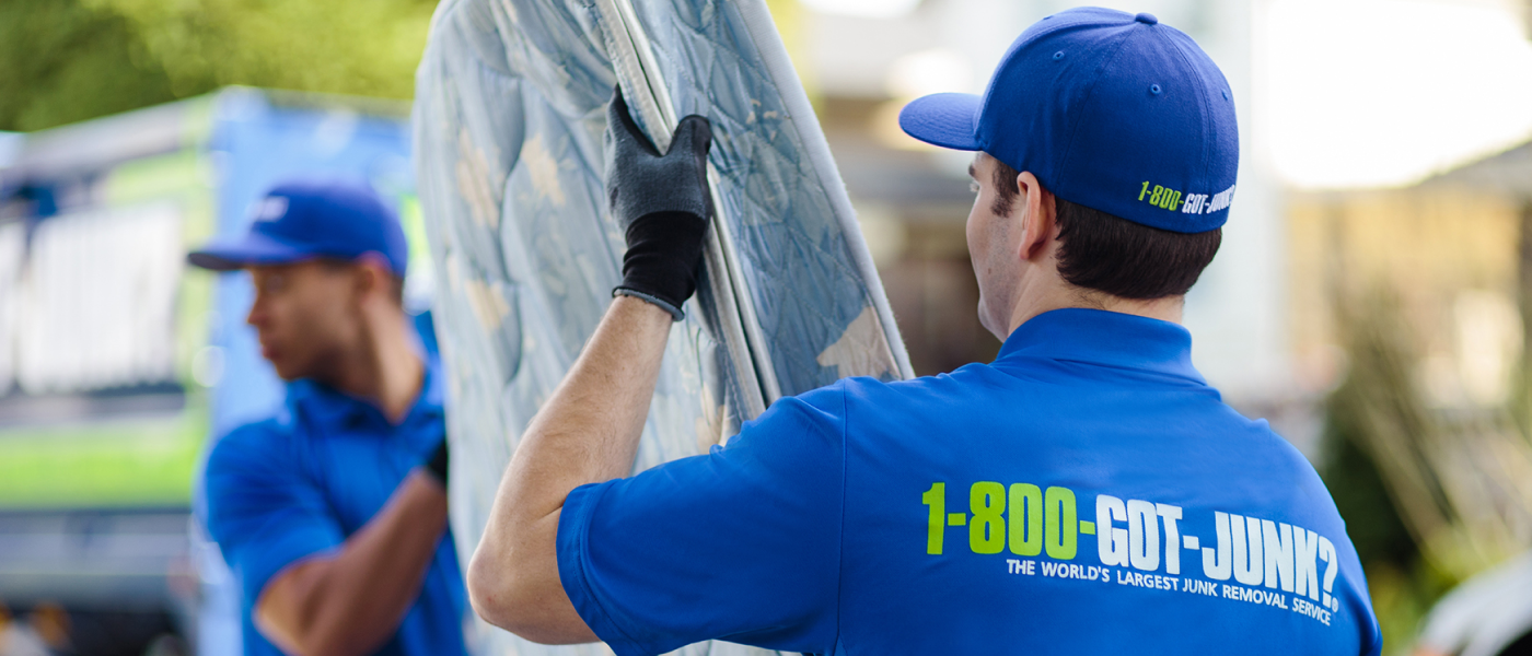 1-800-GOT-JUNK? team disposing of old mattress