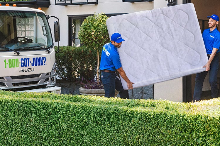 Truck Team Members carrying a mattress 