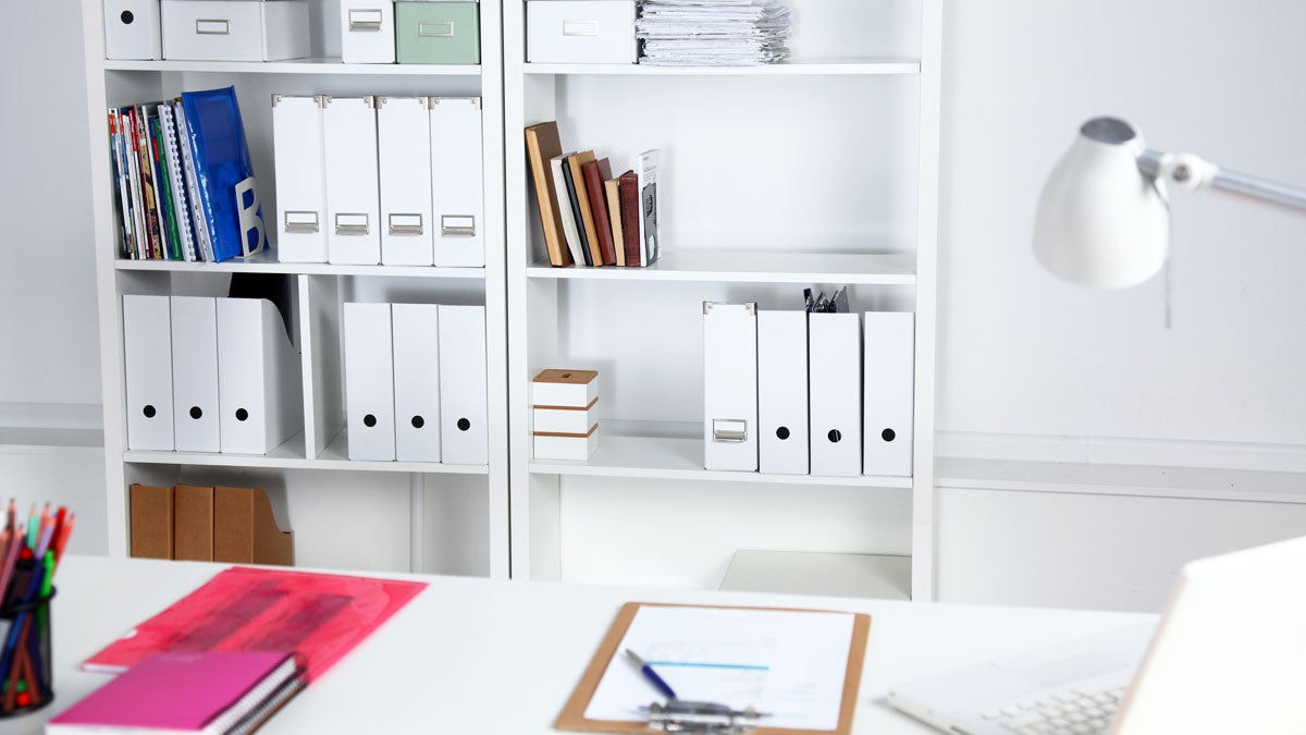 Home office space with white shelf and table