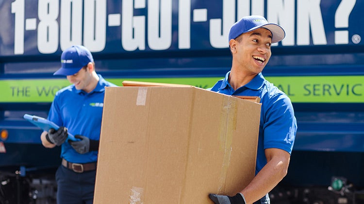 1-800-GOT-JUNK? Truck Team Members removing boxes