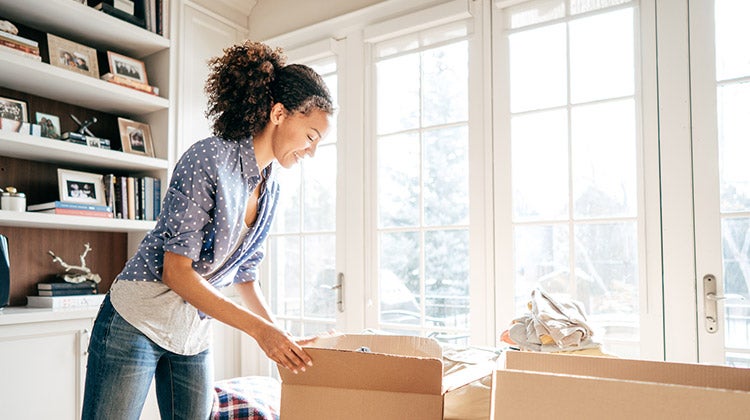 Woman packing up items into boxes