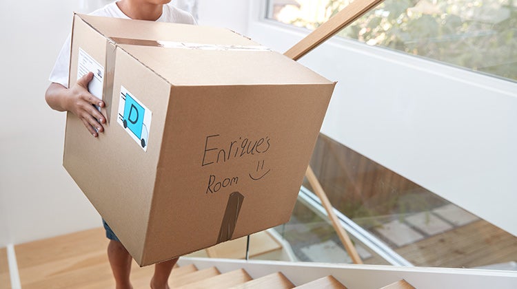 Person holding a labeled moving box