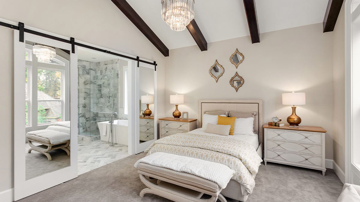 cream bedroom with open ensuite bathroom