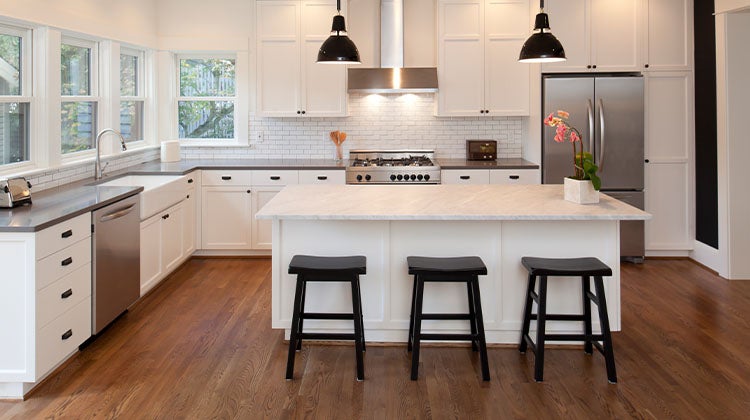 white kitchen with an island and barstools