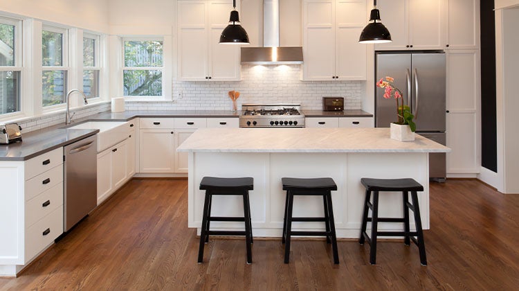 white kitchen with an island and barstools white kitchen with an island and barstools