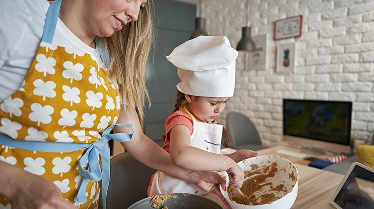 Woman baking with her young daughter 