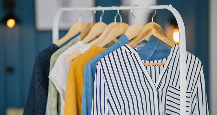 Shirts hung on a white clothing rack