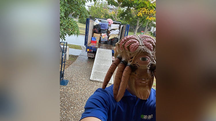 1-800-GOT-JUNK? team member wearing an alien mask 1-800-GOT-JUNK? team member wearing an alien mask