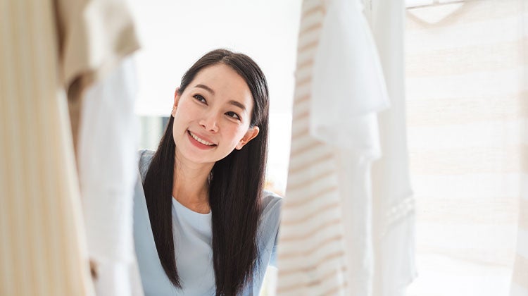 Woman looking into an organized closet 