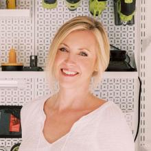 woman smiling next to organized garage wall