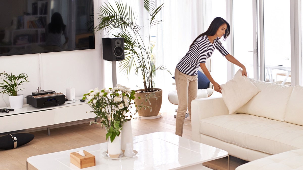 Woman tidying up her living room