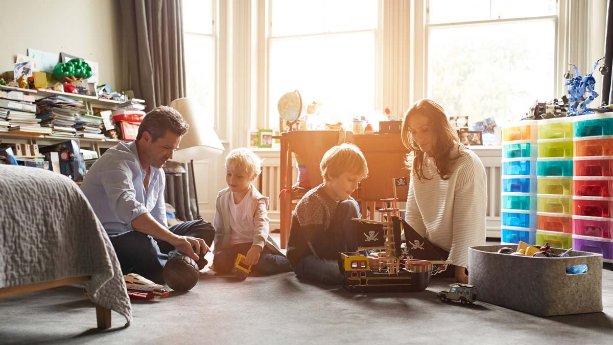 Family decluttering play room for back to school cleaning