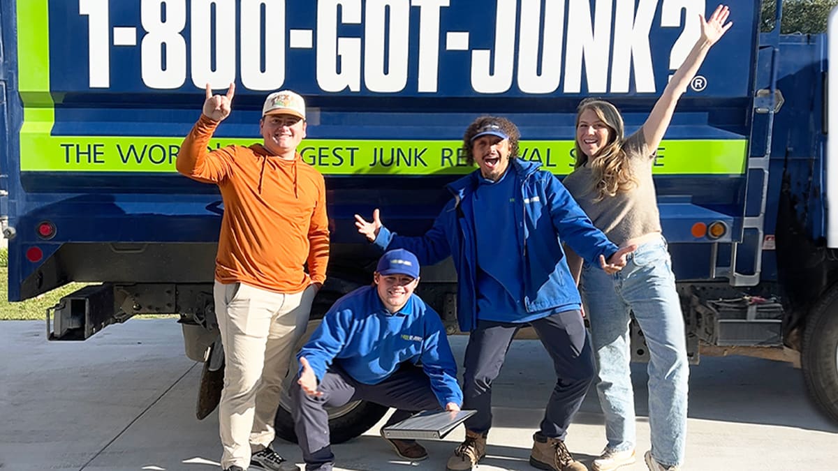 1-800-GOT-JUNK? Truck Team Members and Houston & Morgan standing in front of the truck smiling.
