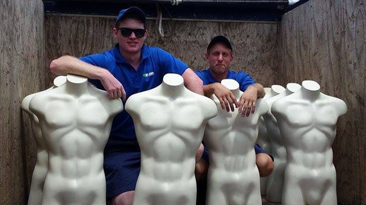 Seven white mannequin torsos in a 1-800-GOT-JUNK? truck 