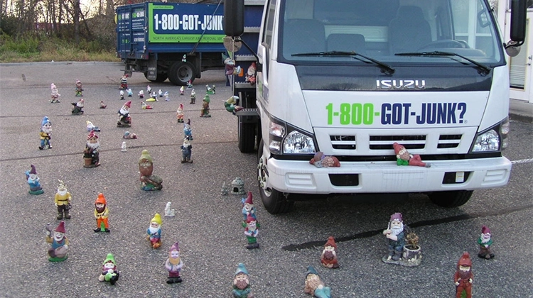 1-800-GOT-JUNK? truck surrounded by lawn gnomes