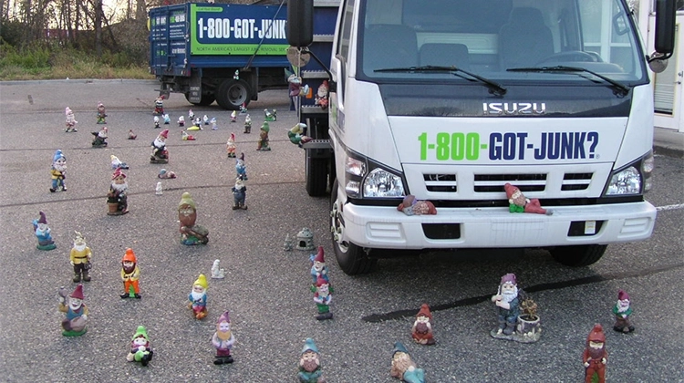 1-800-GOT-JUNK? truck surrounded by lawn gnomes 1-800-GOT-JUNK? truck surrounded by lawn gnomes