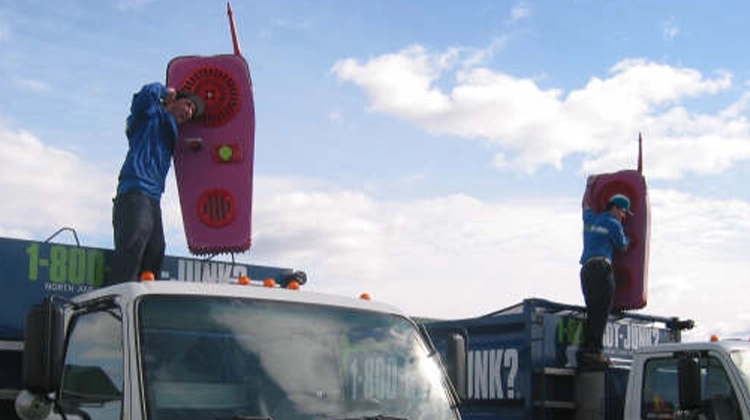 1-800-GOT-JUNK? team members holding giant walkie talkies 1-800-GOT-JUNK? team members holding giant walkie talkies