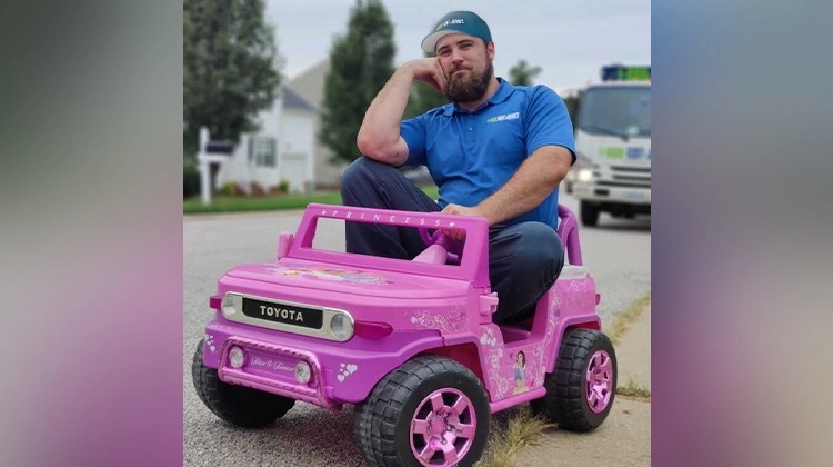 1-800-GOT-JUNK? team member in a pink Barbie Jeep